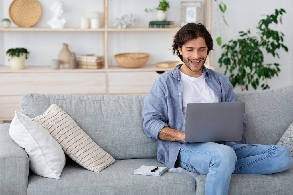 Young man working from home on his laptop
